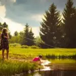 Kids fishing along the river