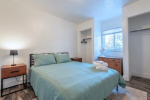 Bedroom with green bedding at The Barn